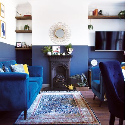 blue and white painted living room with blue sofa