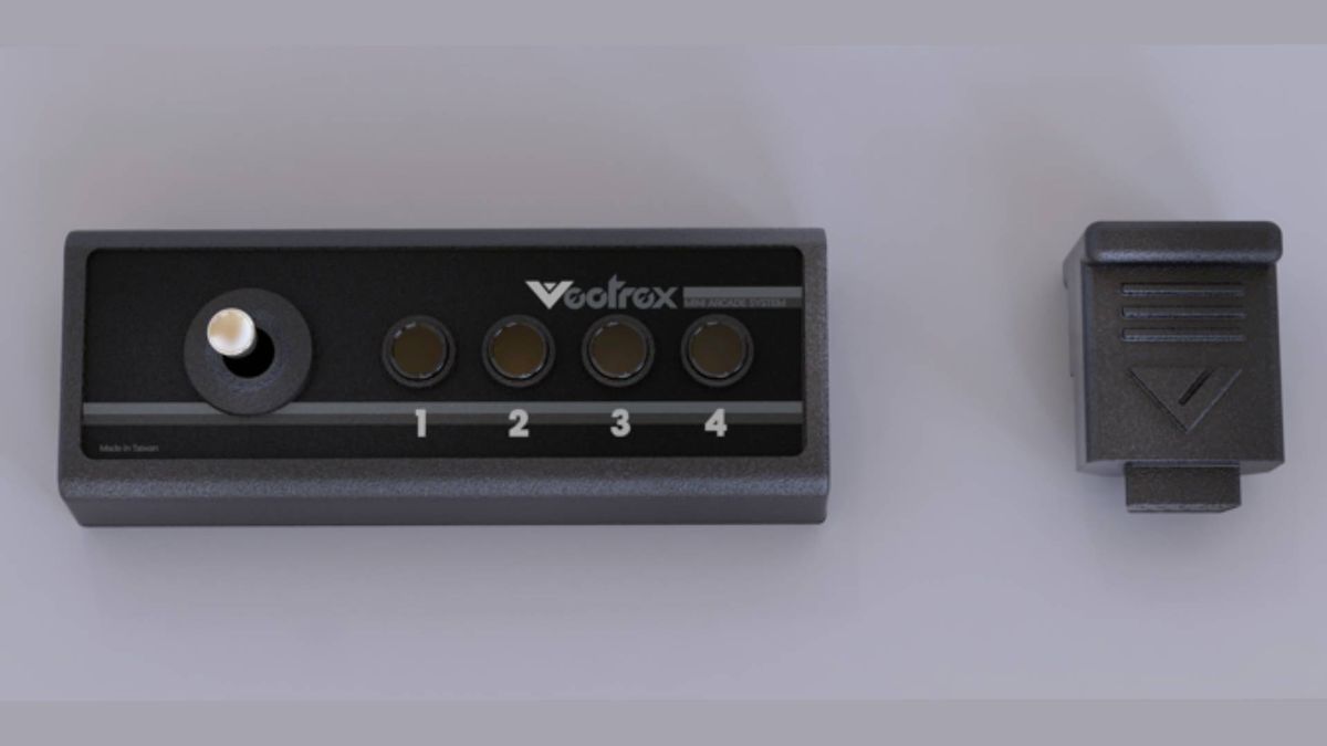 Vectrex Mini controller next to dongle.