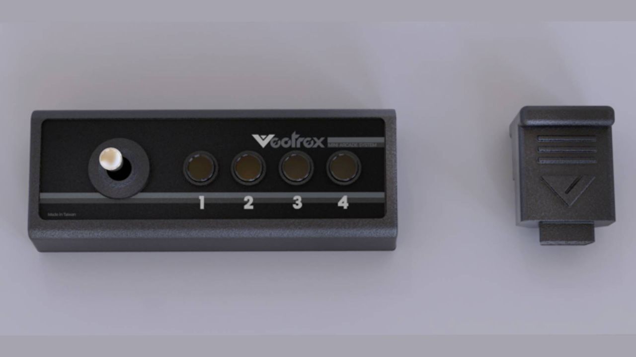 Vectrex Mini controller next to dongle.
