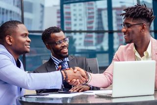 Three men collaborating in a friendly manner