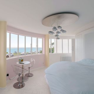 bedroom with white walls and panoramic view windows