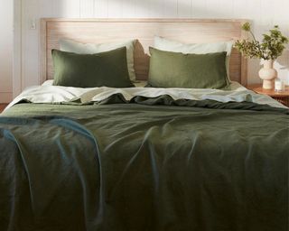 Dark colored bedding styled on bed