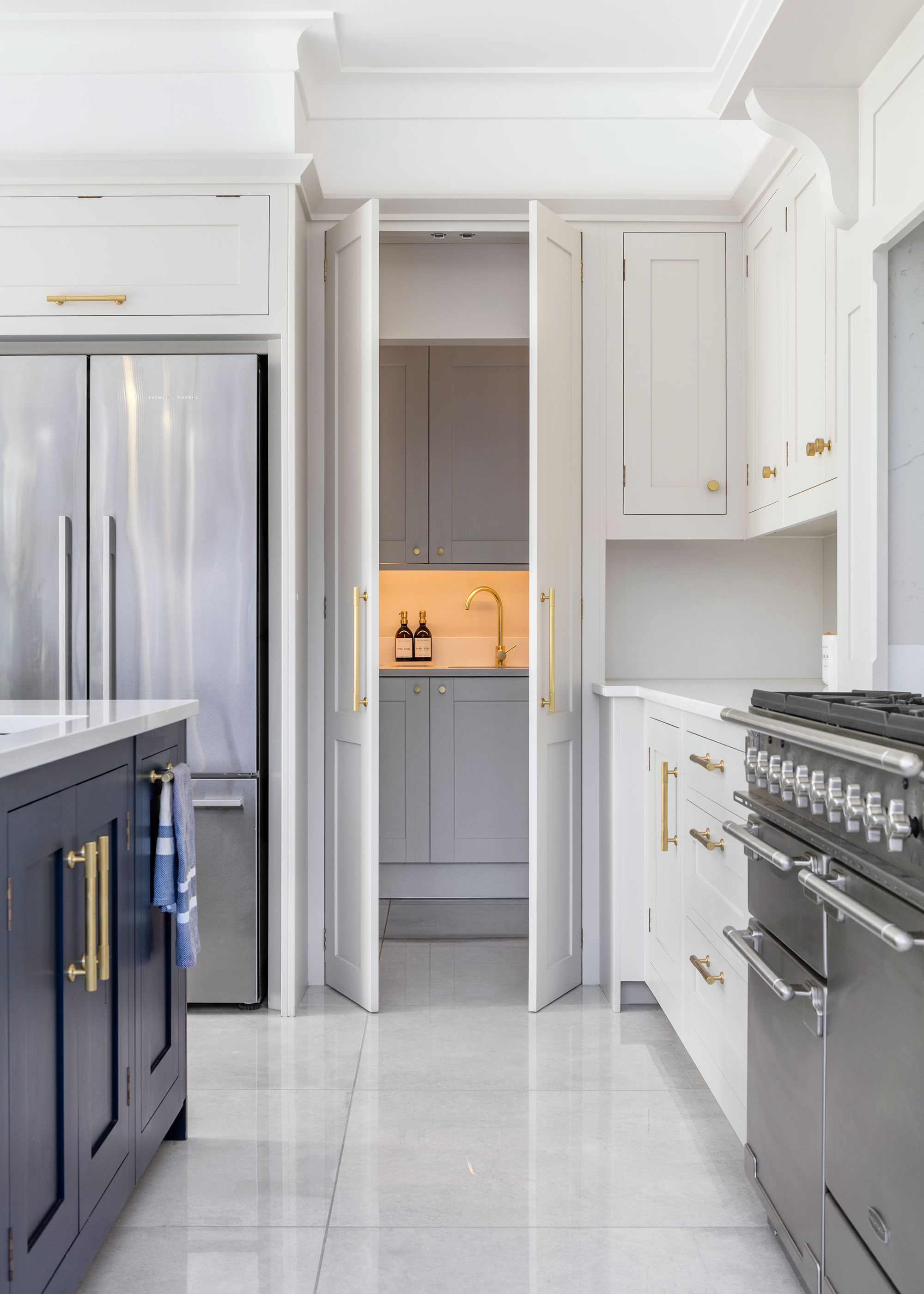 blue and white Shaker kitchen leading to utility room