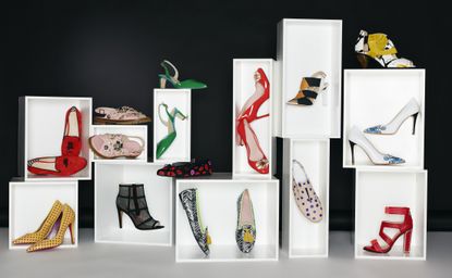 Lots of pretty shoes displayed in white boxes against a black background