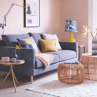 pastel living room with grey sofa and rattan coffee tables