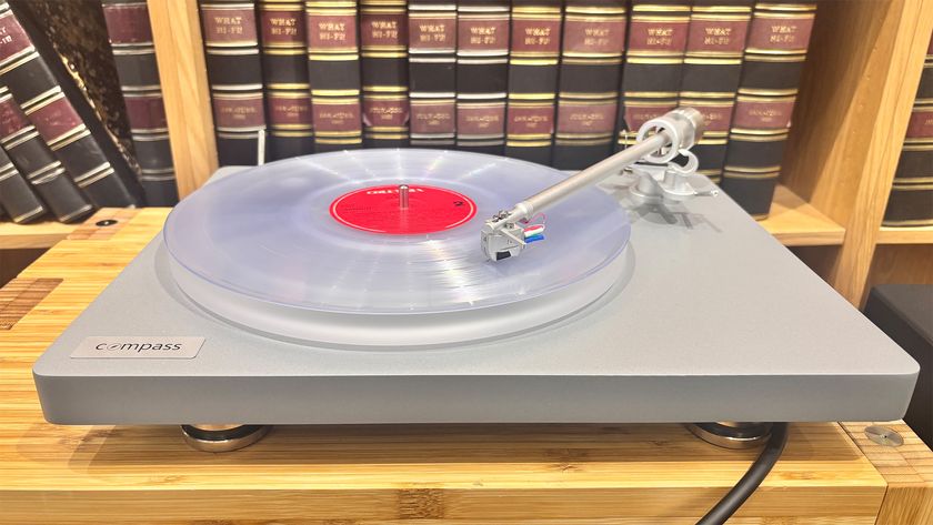 Clearaudio Compass turntable on wooden rack with clear vinyl being played