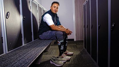 Double amputee Kushal Limbu posing in the locker room at a golf club