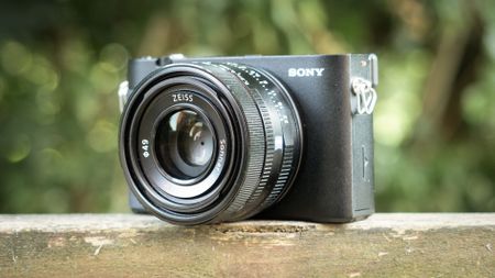 Sony RX1R III on a wooden surface in a woodland environment
