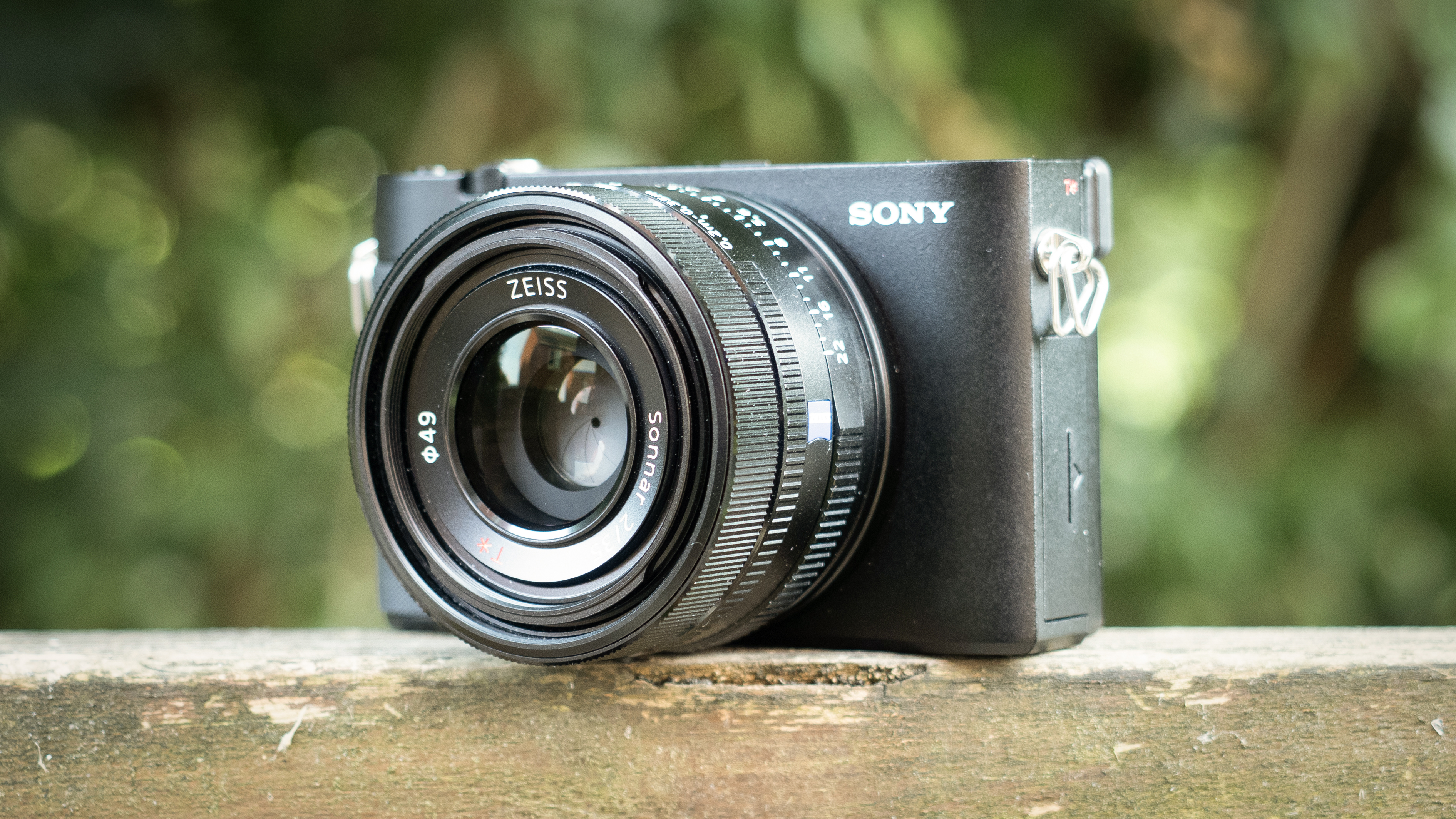 Sony RX1R III on a wooden surface in a woodland environment