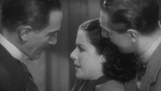 Margaret Lockwood pleading with two men on a train in The Lady Vanishes