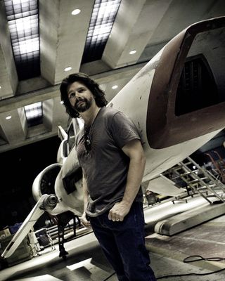 Ron Moore, executive producer of "Battlestar Galactica" (2004-2009), in an undated photo with a Colonial fleet Viper.