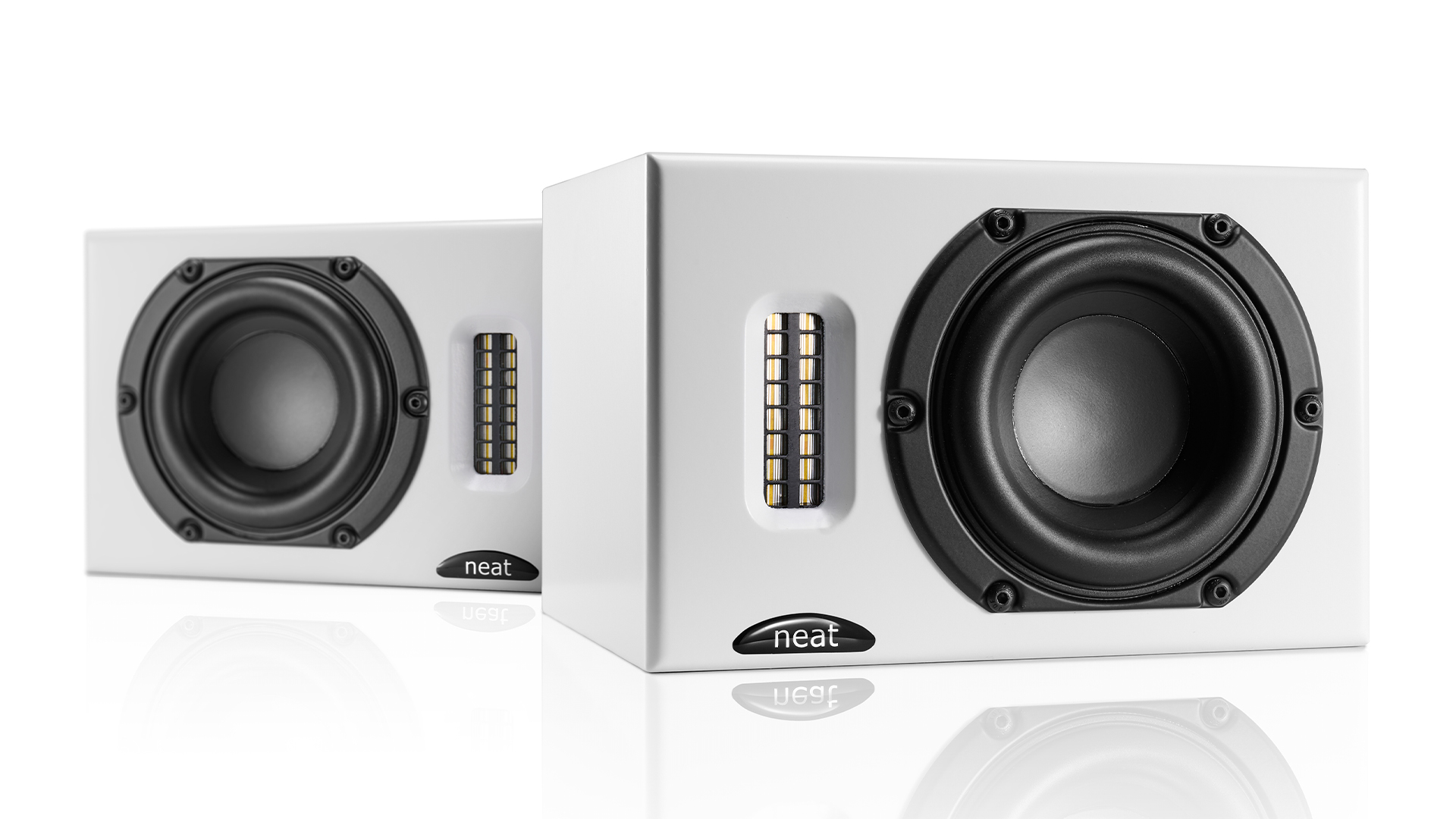 Neat Iota II speakers in white finish against white background