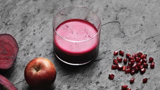 Glass of beetroot juice with apple and pomegranate seeds