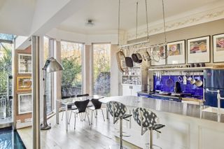 Open plan kitchen with island and blue tiled splashback