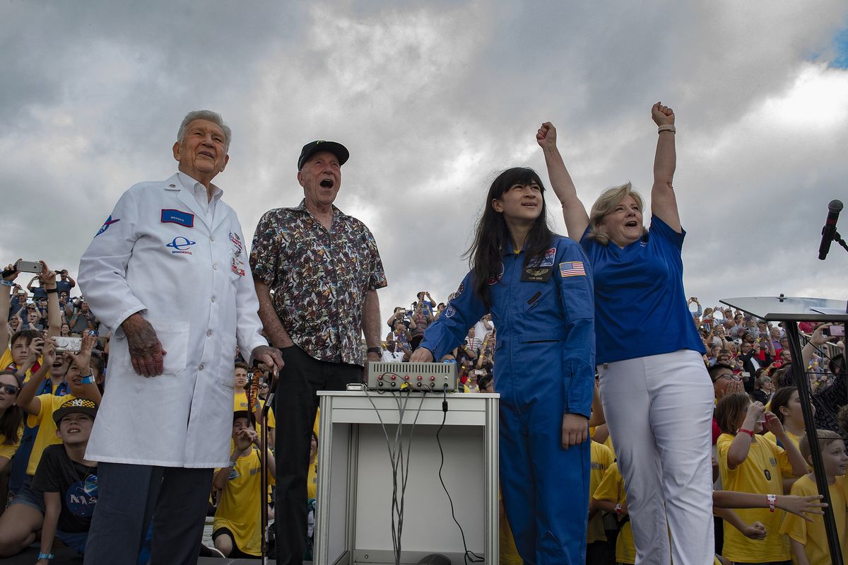 Jody Singer (far right) director of NASA's Marshall Space Flight Center, celebrates as thousands of model rockets launch at the U.S. Space &amp; Rocket Center in Huntsville, Alabama on July 16, 2019. Also looking on (from left) are retired Marshall engineer Brooks Moore, Apollo 15 command module pilot Al Worden and Space Camp veteran Lillian Duran.