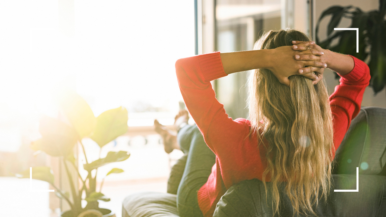 Woman looking anxiously out of window