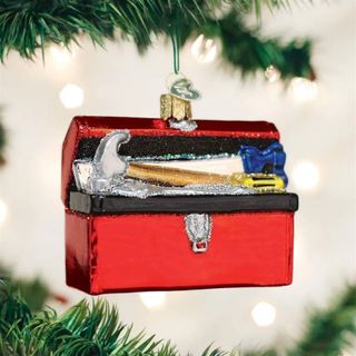 Small red toolbox ornament hanging from christmas tree