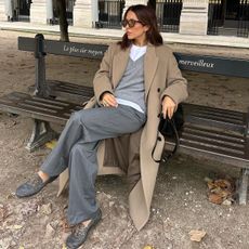 woman in camel coat and gray outfit