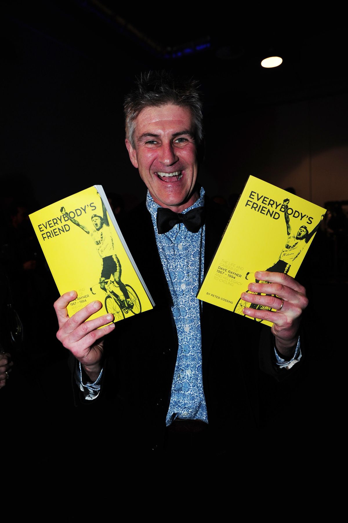 Author Peter Cossins holds up copies of 'Everybody's Friend', his new book about Dave Rayner