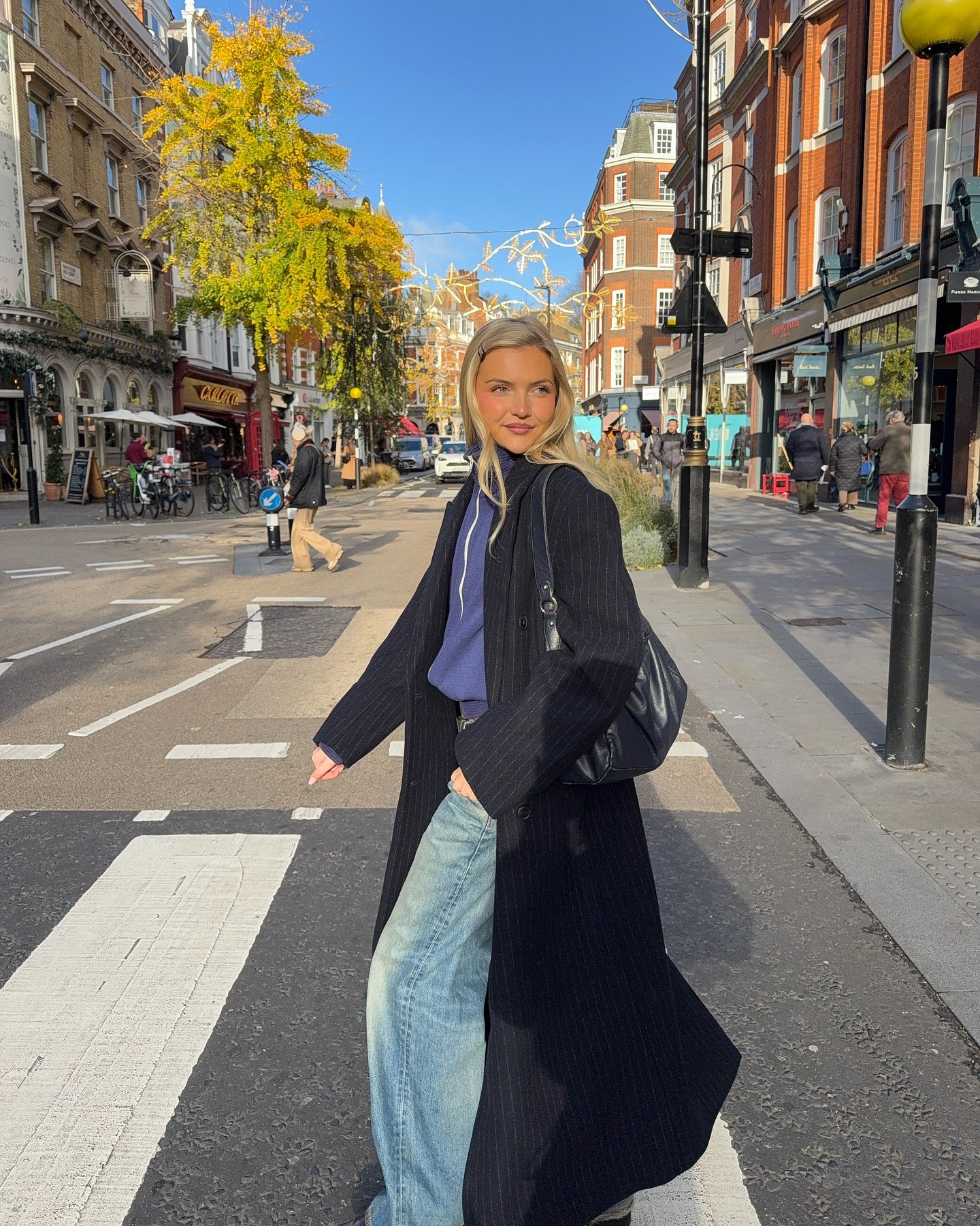 Fashion person Miais obelle barker wears a best long wool coat. She wears a pinstriped maxi coat.