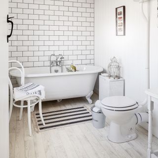 White bathroom with painted floor and white fixtures