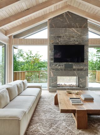 Cottage with stone indoor outdoor fireplace