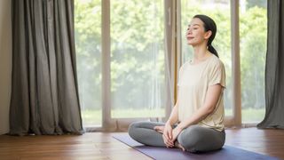 Is yoga safe during pregnancy? image shows woman doing yoga breathing exercises