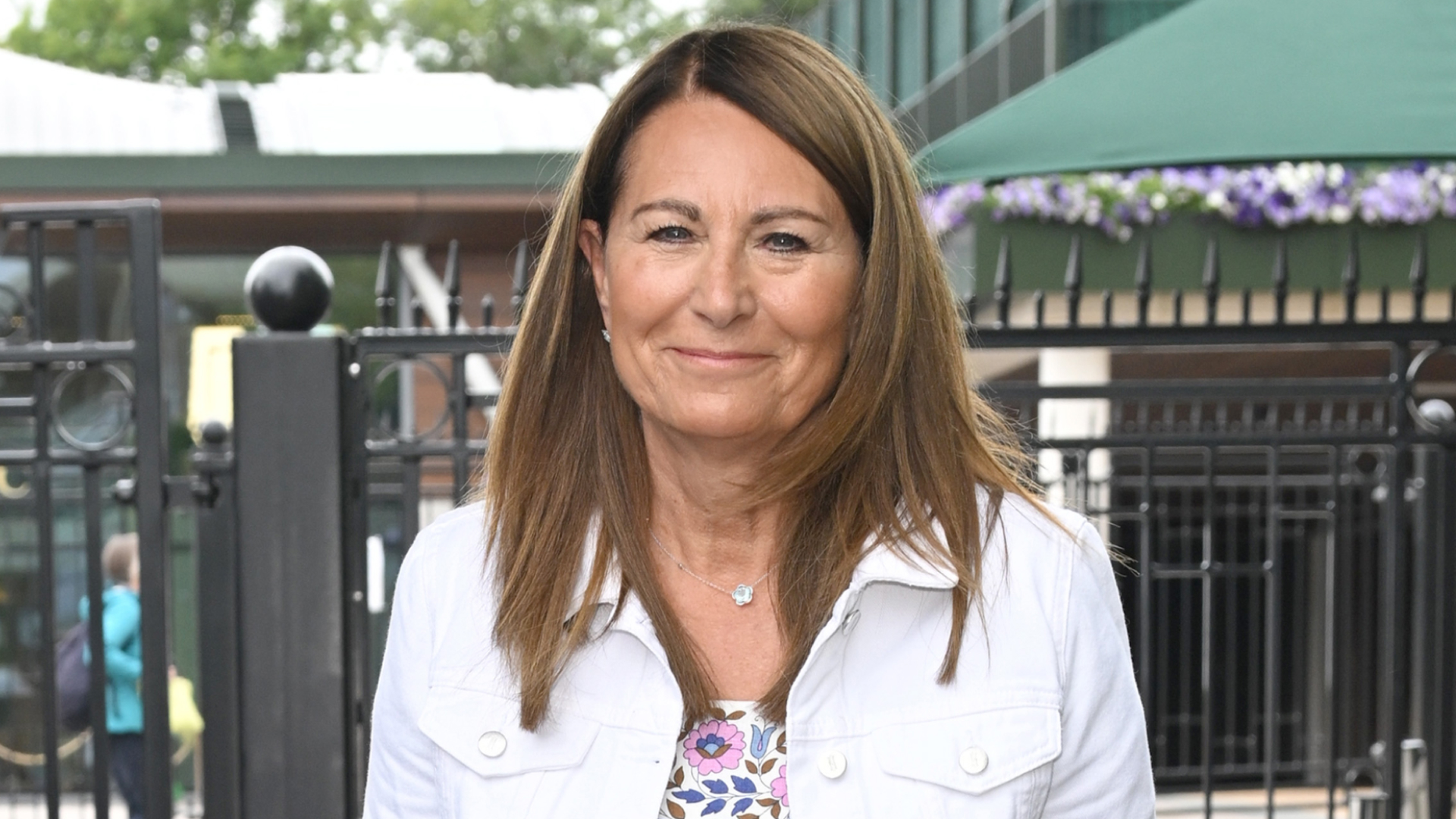 Carole Middleton wearing a white denim jacket and a floral dress at Wimbledon 2022 at the All England Lawn Tennis and Croquet Club on June 29, 2022 