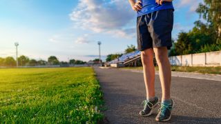 Man does calf raise exercise on running track