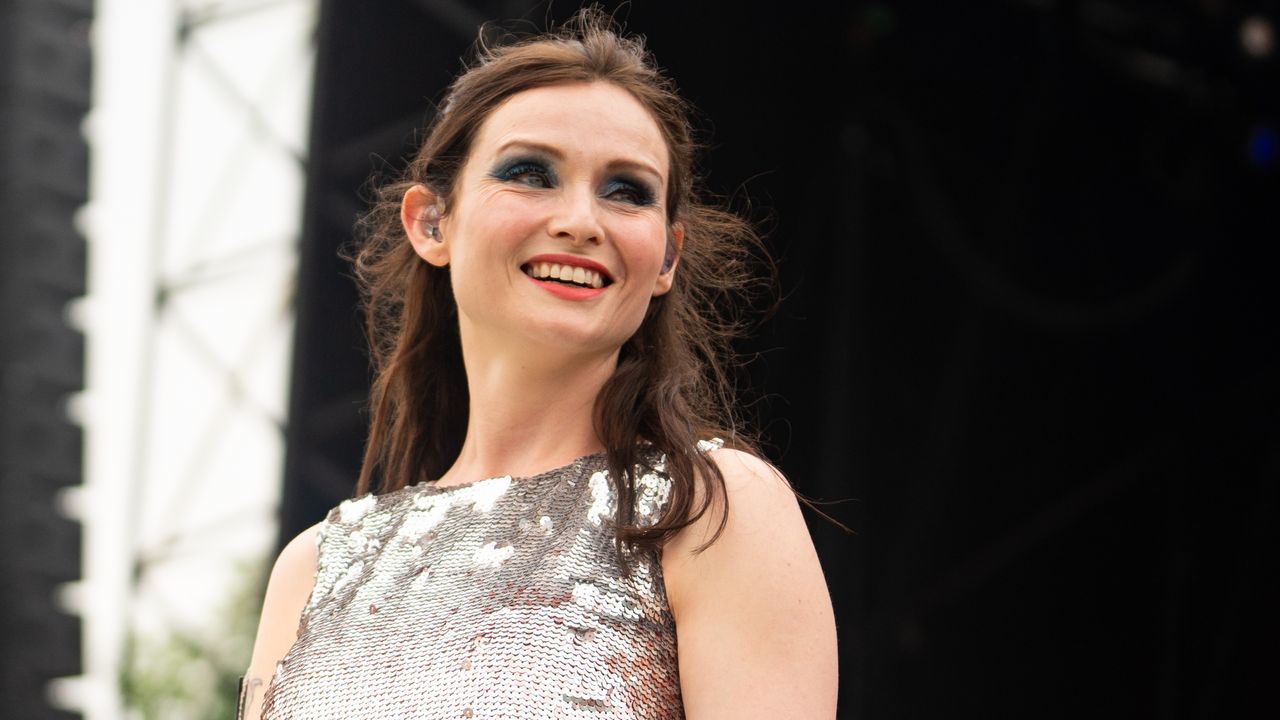 Sophie Ellis-Bextor on stage, wearing a sequinned dress and smoky green eyeshadow