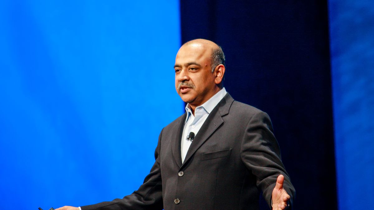 IBM CEO Arvind Krishna delivers a speech in front of a blue backdrop