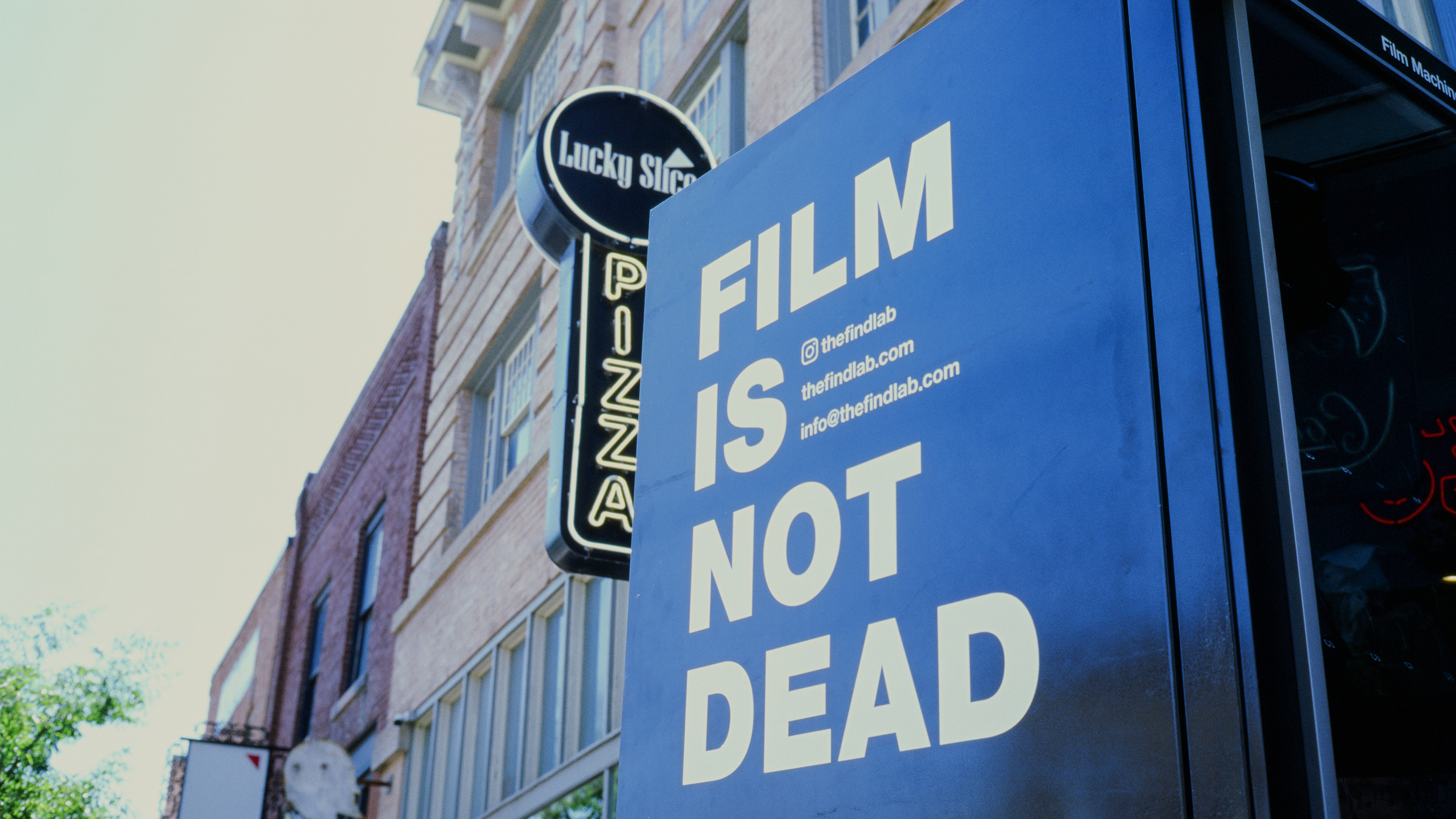 A film vending machine sits outside Lucky Slice Pizza, ready to be installed