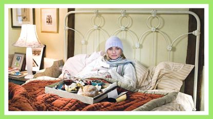 Cameron Diaz in The Holiday—one of the best Christmas movies on Hulu—in bed with warm clothes on—image with a green border around it
