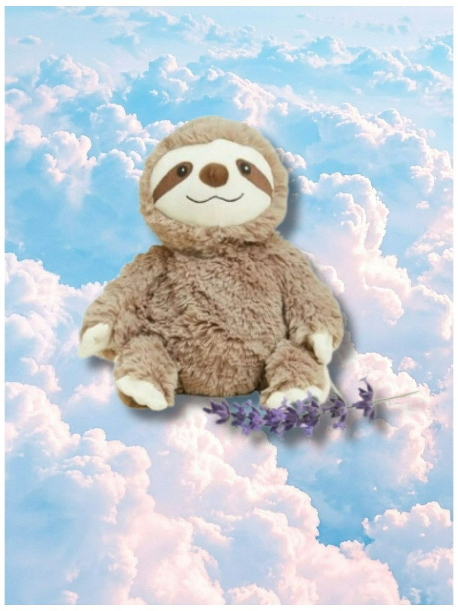 Weighted plush sloth on a dreamy pastel cloud background.