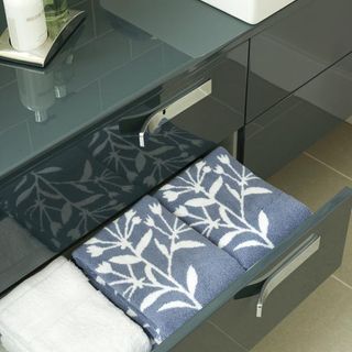 drawers with dark grey and towels