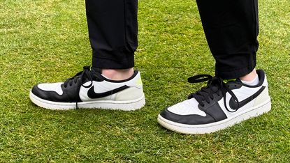 The Nike Air Jordan 1 Low golf shoe pictured on a tee box 