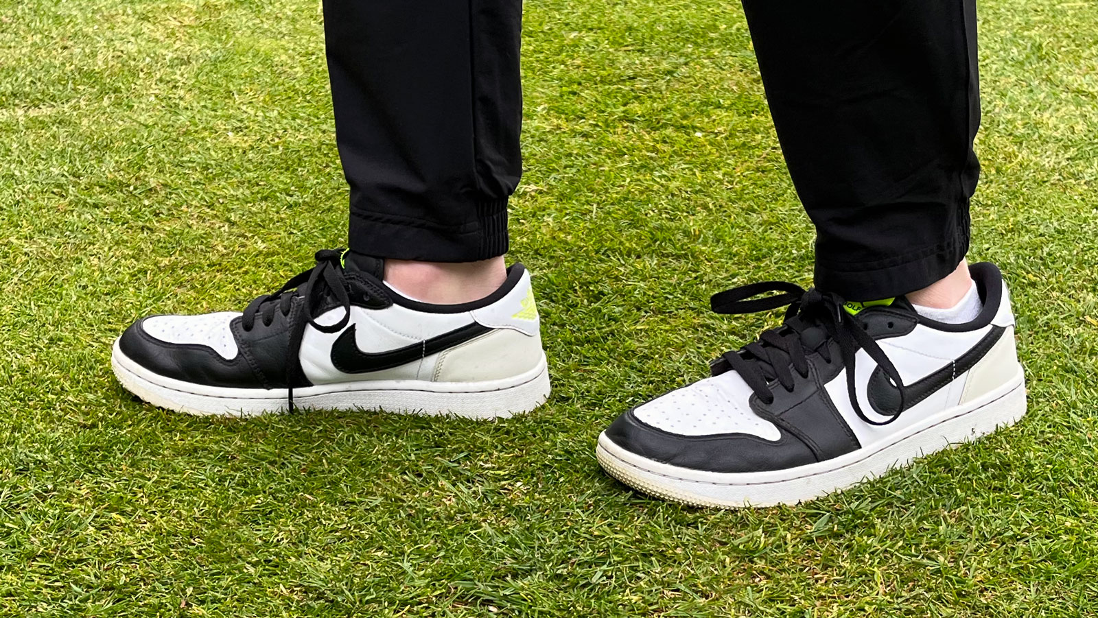 The Nike Air Jordan 1 Low golf shoe pictured on a tee box