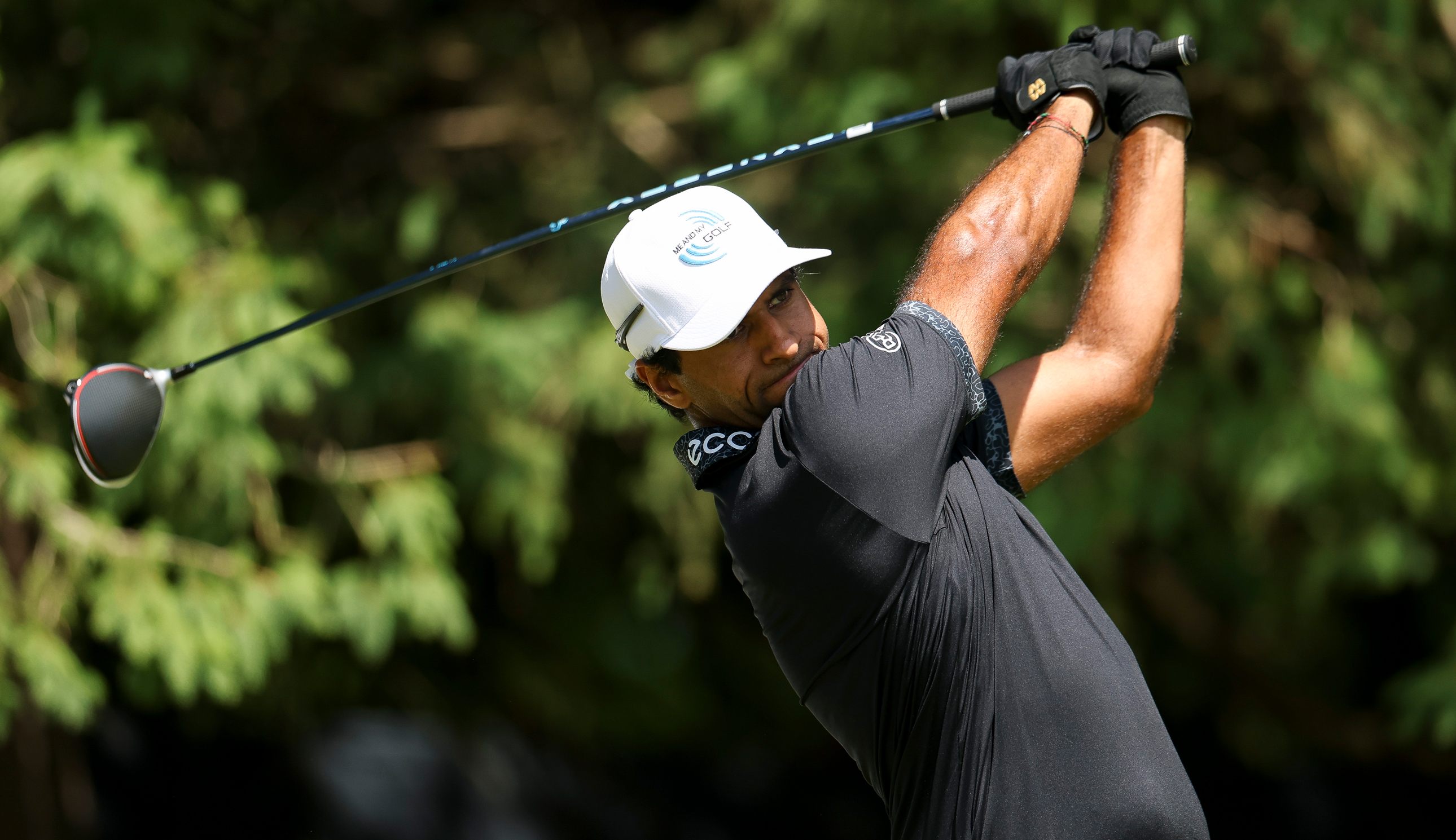 Aaron Rai hits a driver off the tee and watches its flight