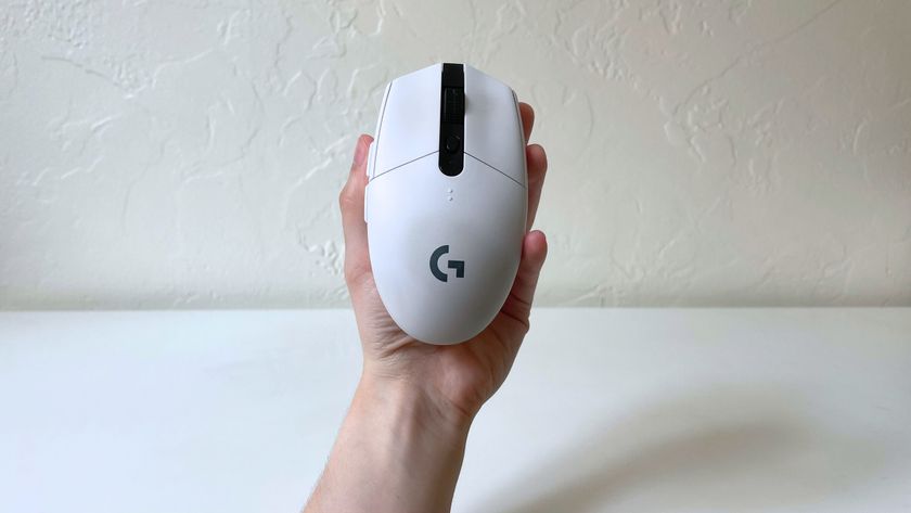 The Logitech G305 LIGHTSPEED in someone&#039;s hand with the top of the mouse visible