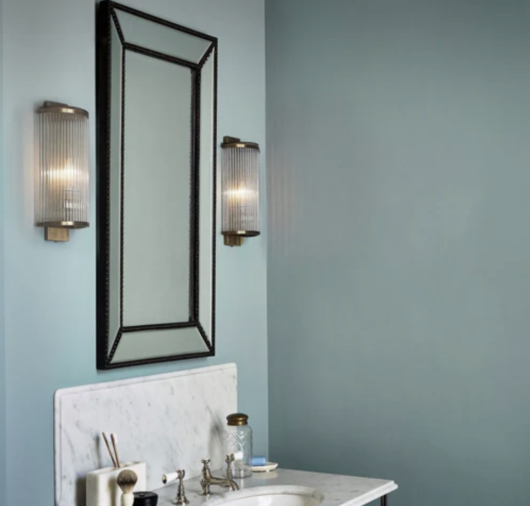 reeded bathroom lights in a bathroom with blue walls