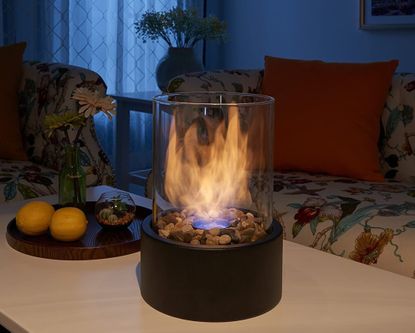 A small firepit on a coffee table in a living room