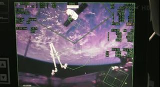 This view from a computer display inside the International Space Station shows SpaceX's Dragon capsule as it approaches to be grappled by the station arm on Oct. 10, 2012.