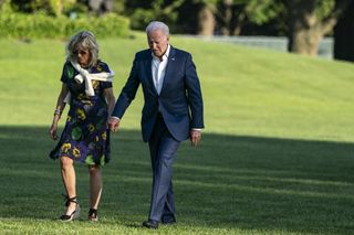 U.S. President Joe Biden and U.S. First Lady Jill Biden walk on the South Lawn of the White House after arriving on Marine One in Washington, D.C., U.S., on Sunday, June 27, 2021.