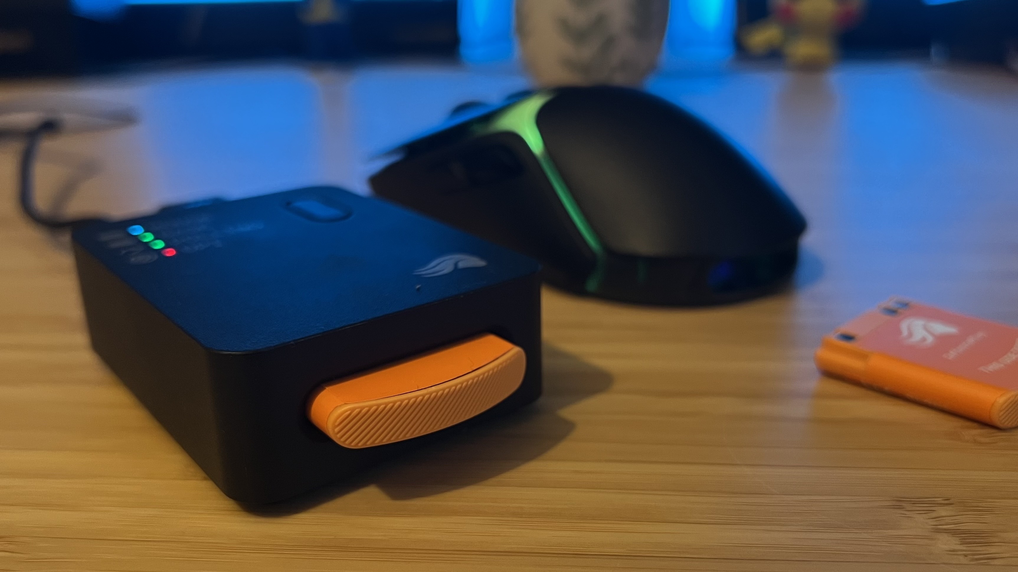 Glorious Model O 3 Wireless with charging / connection hub on a wooden desk