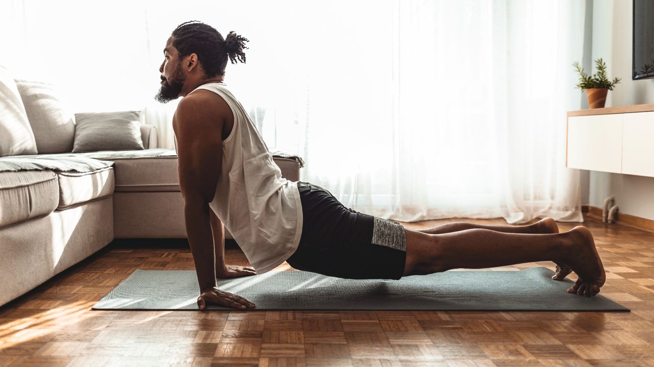 Man practicing yoga at home