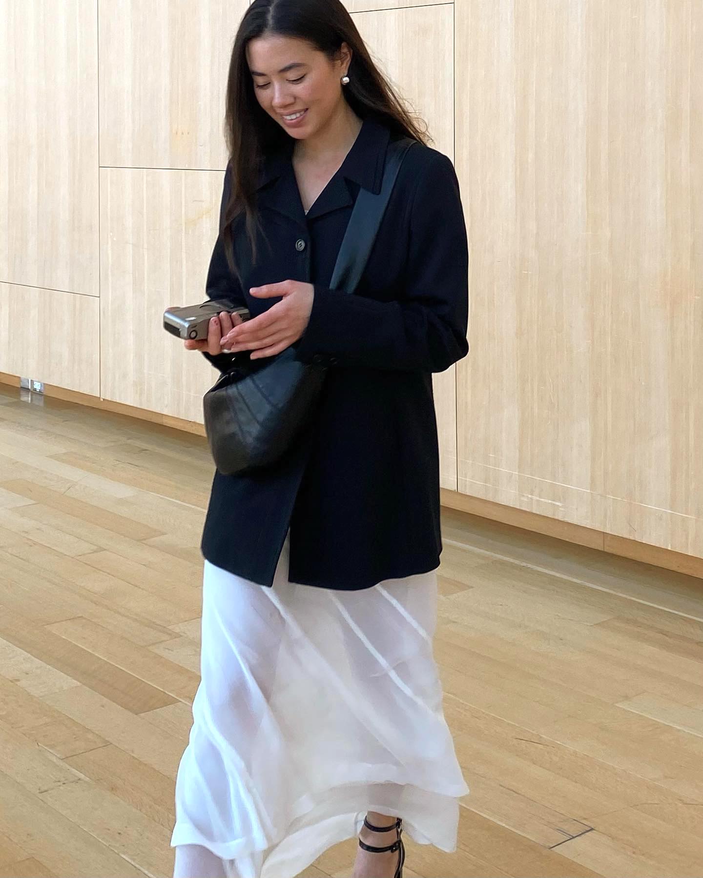 fashion influencer Sasha Mei wears a sheer white dress and black blazer