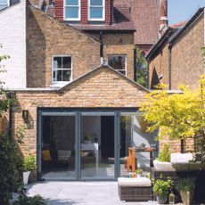 pitched roof rear extension on a semi detached brick house with grey anthracite sliding doors