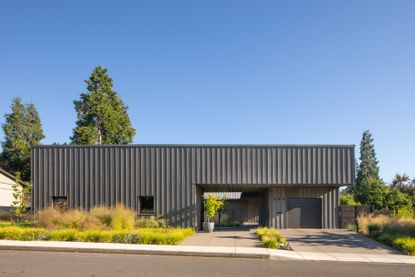 meadow house in oregon against blue skies with its grey, low orthogonal volume