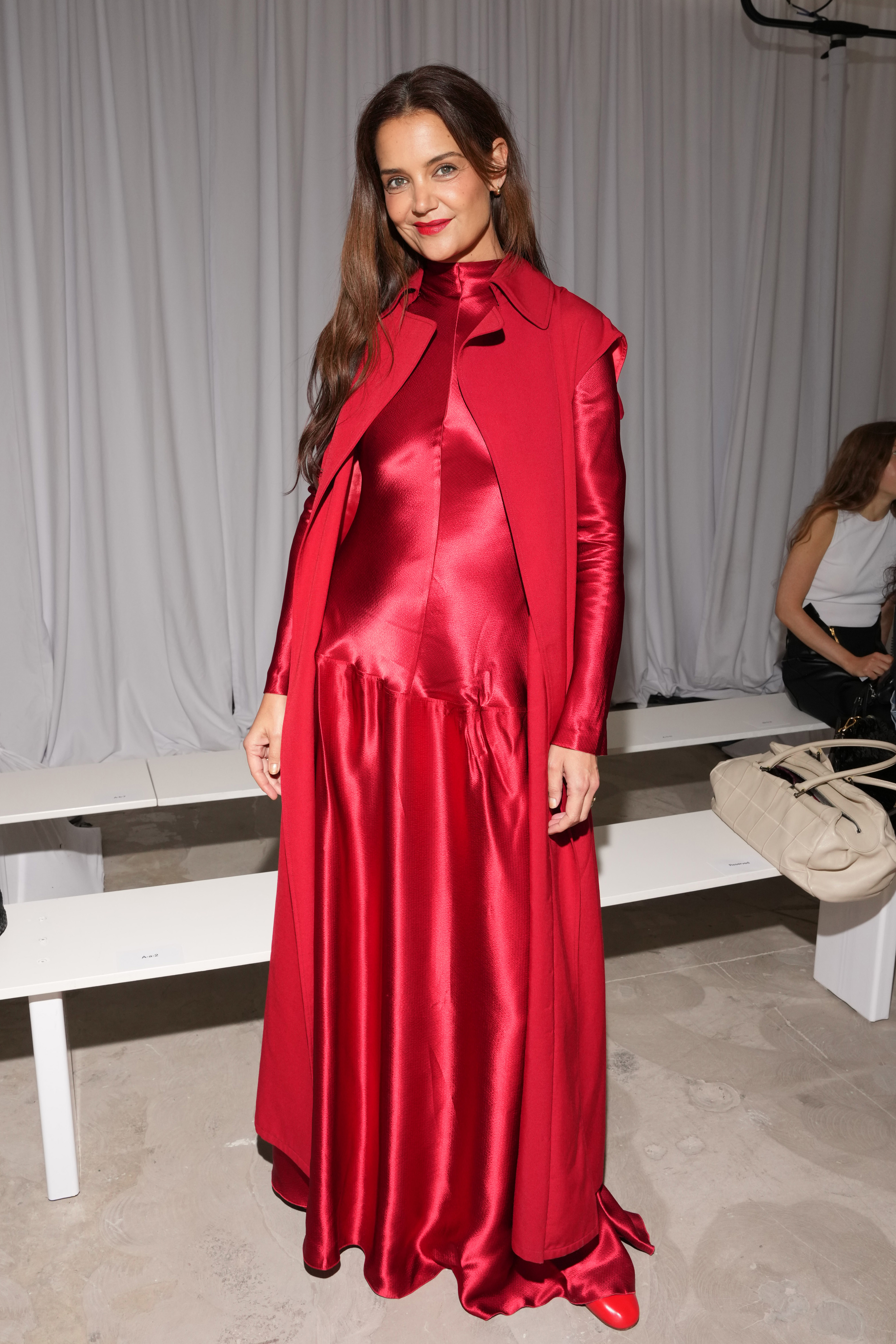 Katie Holmes weres a bright red long-sleeve gown to attend the FFORME S/S26 Show during New York Fashion Week on September 12, 2025