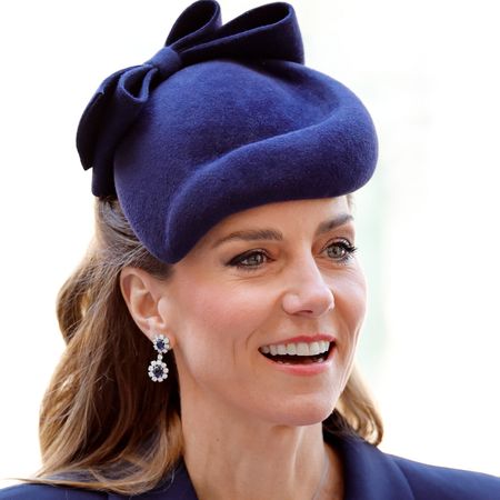 Princess Kate wearing a blue hat and smiling